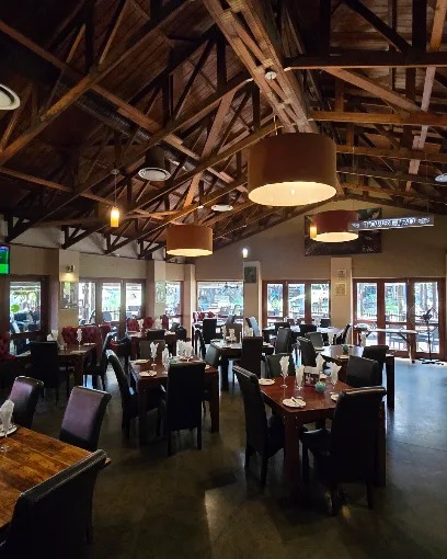 Spacious restaurant dining area beneath exposed wooden beams