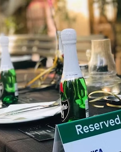 A reserved event table set with glasses and napkins
